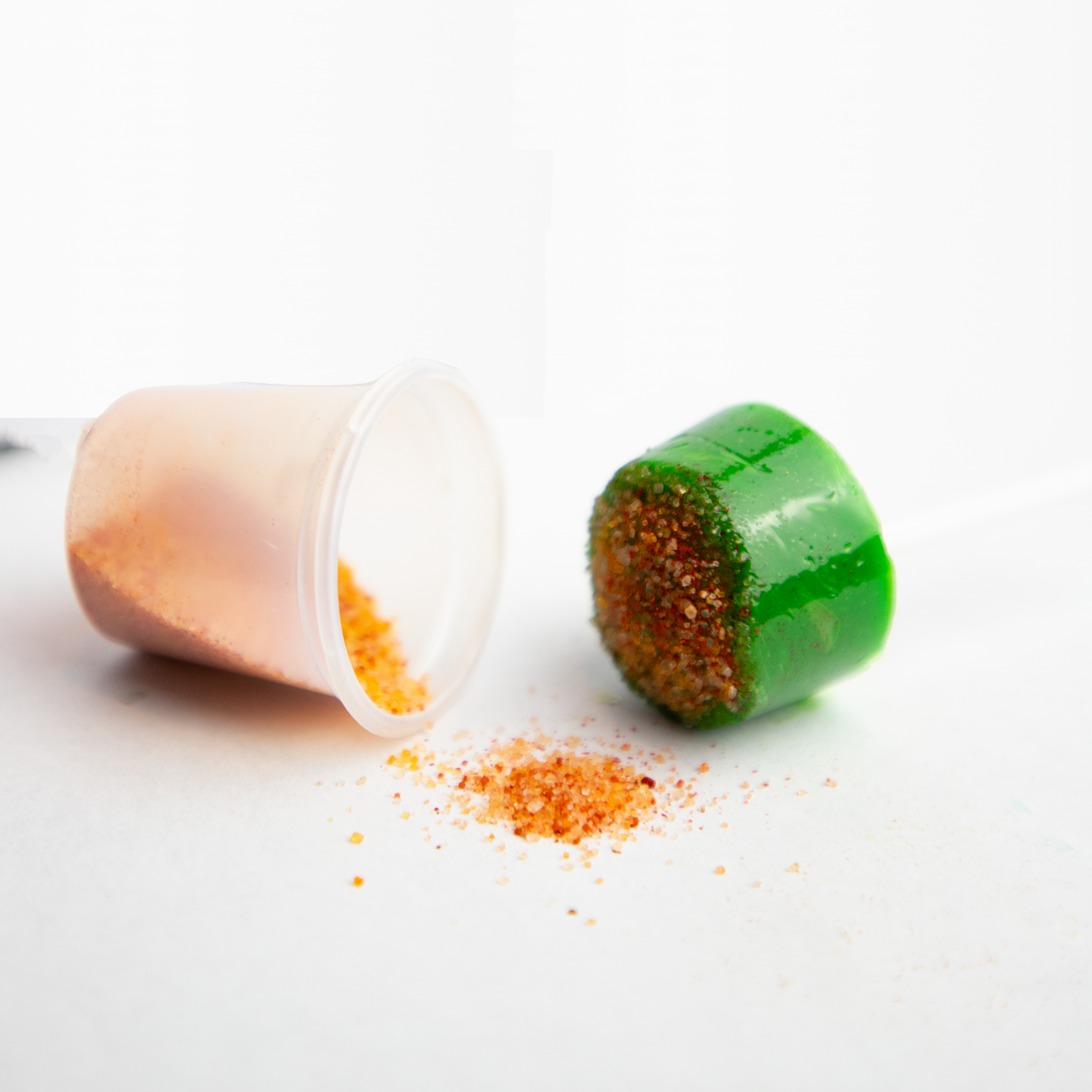 Green apple hard candy lollipop with chili powder Mexican candy